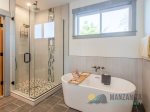 Walk-in shower and a modern soaking bathtub.