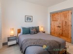A comfortable bedroom with blackout shades for daytime naps.