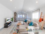 The loft area has a TV and a large sectional.