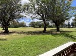 View from lanai table of golf course and mesquite kiawe trees