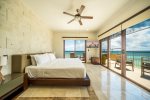 Master bedroom with balcony and ocean views 