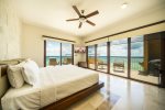 Master bedroom with balcony and ocean views 