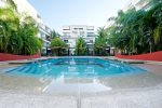 The Sabbia Condos common area pool with lounge chairs
