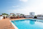 The Casa del Mar rooftop pool with beds, lounge chairs and ocean view