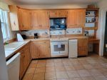 Coastal themed tile decor and all amenities in the kitchen
