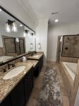 Master bathroom with oversized tub, glass shower and double vanity