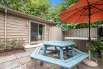 Daisy Cottage has a beautiful backyard setting with a picnic table on the patio and the relaxing hot tub