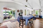 Kitchen area opens to the screen porch through the large French doors