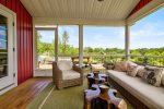 Screen porch leads out to the expansive tiered decking and hot tub 