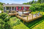 Truly this is amazing outdoor space with expansive tiered decking, a hot tub, and fire pit