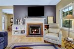 Living room has a seasonal fireplace and a large Smart TV to stream your favorite apps