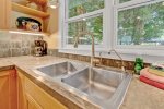 Kitchen overlooks the back patio and yard 