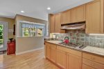 Full kitchen with adjacent dining room and access to the screen porch 