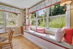 Dining room has a cozy window seat where you can curl up with a good book 