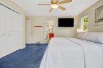 Spacious primary bedroom with king bed, Smart TV, ensuite bathroom, and access to a private deck