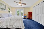 Spacious primary bedroom with king bed, Smart TV, ensuite bathroom, and access to a private deck