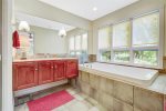 Primary bathroom has a large soaking jetted tub perfect for relaxing at the end of the day