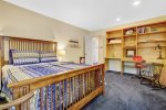 Guest bedroom with a queen size bed overlooking the patio and backyard