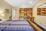 Guest bedroom with a queen size bed overlooking the patio and backyard