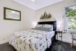 Guest bedroom with a queen size bed overlooking nature 