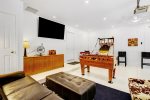 Amazing game room includes a smart TV and lounge area plus a selection of table games and board games