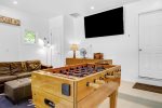 Amazing game room includes a smart TV and lounge area plus a selection of table games and board games