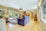 Spacious living room with plenty of seating and French doors that lead to the patio 