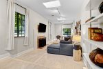 Just off the kitchen space is this bright family room area with sectional sofa, work area, and smart TV