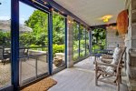 You will love relaxing on the screen porch overlooking the backyard 