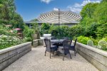 Just off the screened patio is this outdoor patio with BBQ grill and dining table 