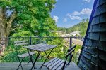 Balcony with a cafe table and partial river views 