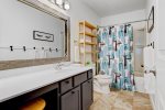 Guest bathroom with a shower tub combo 