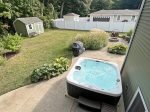 Backyard space with a hot tub, fire pit, BBQ grill, and outdoor dining 