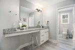 Guest bathroom with separate vanity area and a shower tub combo 