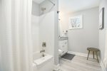 Guest bathroom with a shower tub combo 