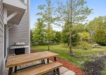 Sliders from the kitchen go to the patio with BBQ grill and picnic table 