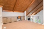 Upper level living area with a sofa sleeper overlooks the main level living area