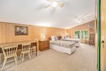 Back bedroom in the carriage house has two twin beds and a table perfect for dining or work