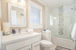 Upper level full bathroom with a shower tub combo 