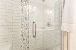 Walk in shower in the lower level bathroom