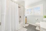 Upper level full bathroom with a shower tub combo 