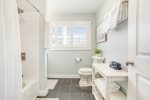 Upper level full bathroom with a shower tub combo 