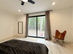 Primary bed overlooks the backyard 