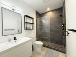 Main level bathroom with a custom tile shower. 