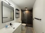 Upper level bathroom with a tile walk in shower and amenities included 