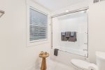 Main level full bathroom with a shower tub combo 