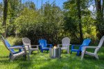 Fire pit area in the lush backyard for s`mores under the stars