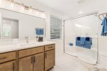 Upper level bathroom with a shower and large vanity 