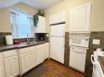 Fully equipped kitchen with dishwasher, full size refrigerator, and apartment size range