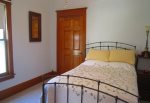 Main level bedroom with full size bed and adjacent full bathroom
